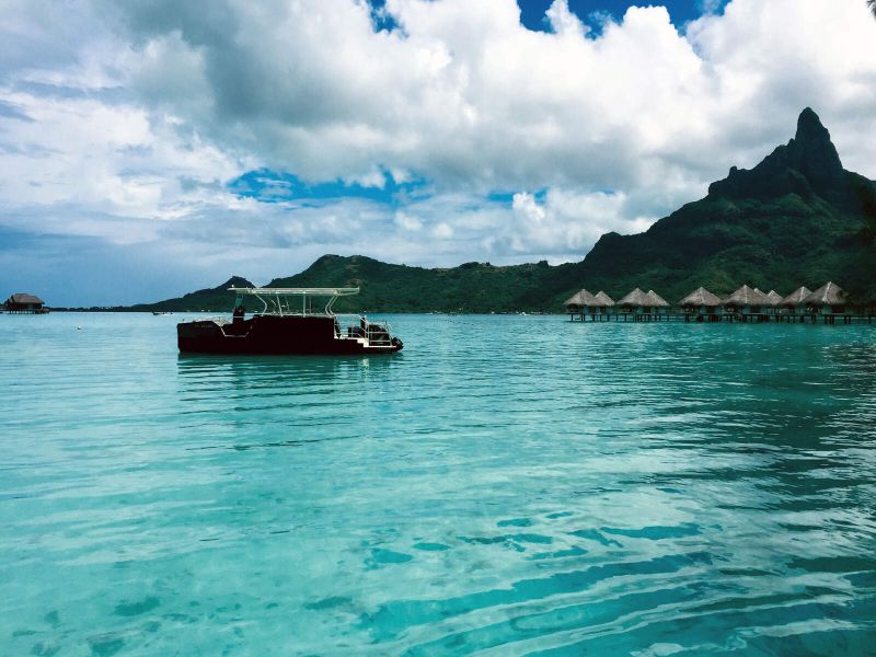 The Bora Bora lagoon and a boat in front of Mount Otemanu